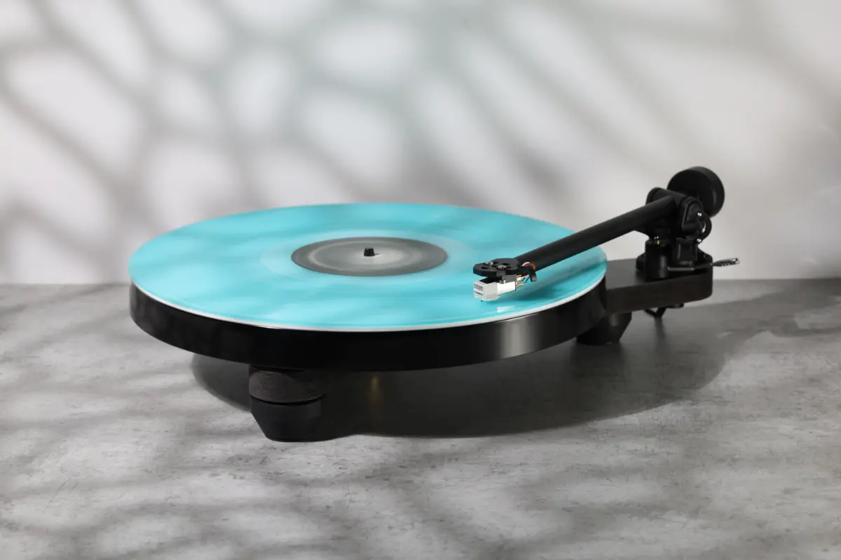 Platine vinyle Rega Replay noire avec un disque sur le plateau